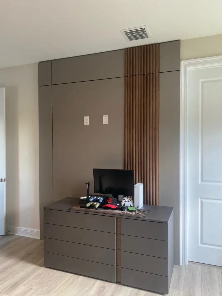 Bedroom accent wall with vertical wood slats, upholstered panels and a matching dresser