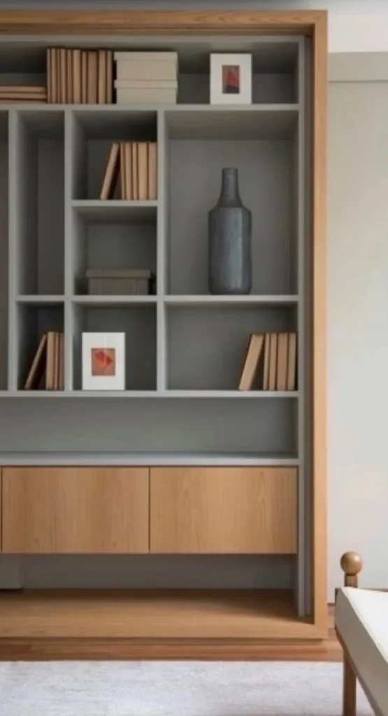 Built-in bookcase with gray open shelving and oak lower cabinets