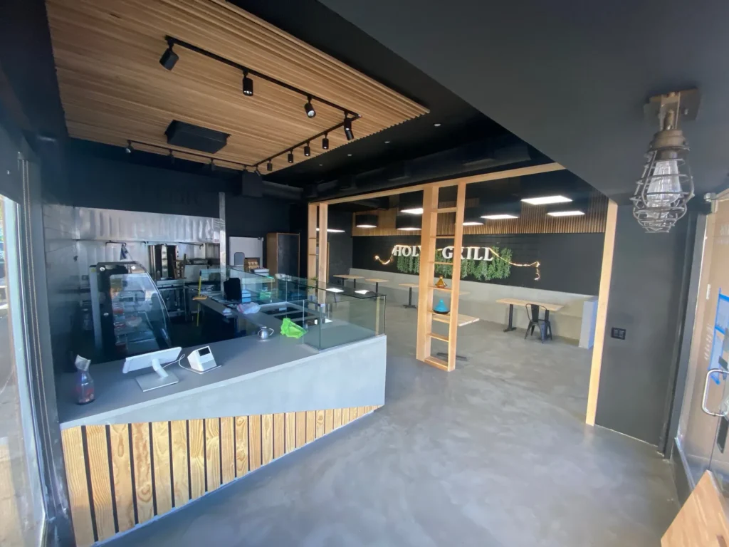 Café build-out with a wood slat ceiling, wood-clad counter and display case