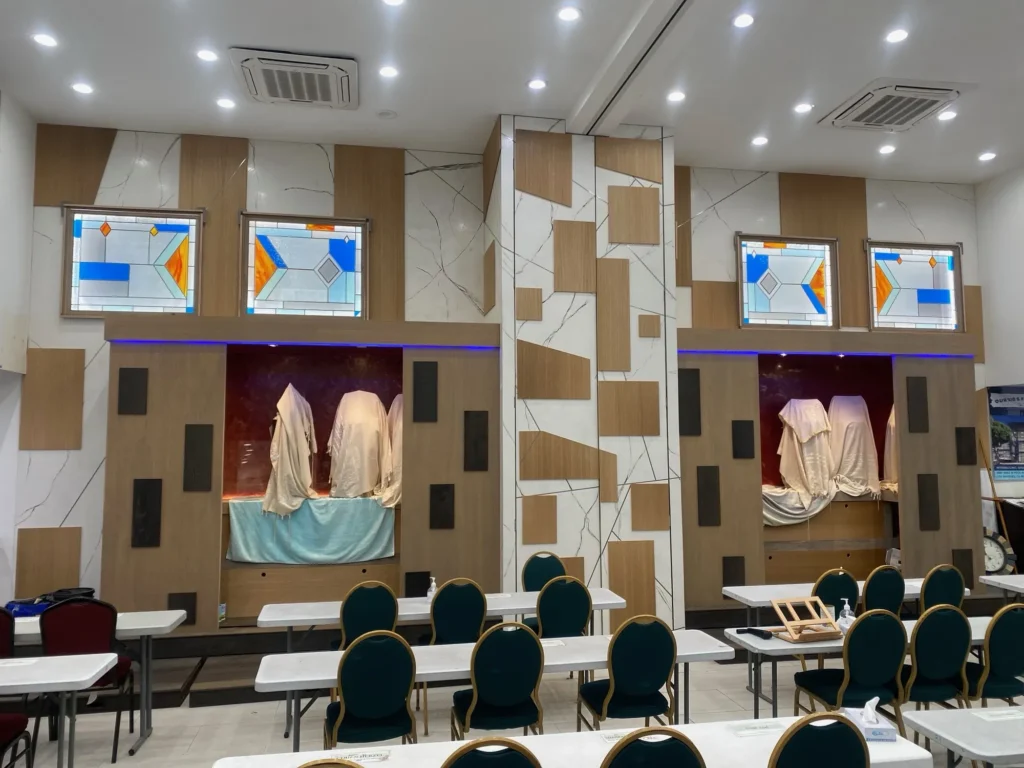 Event hall with a large geometric feature wall in wood and white panels