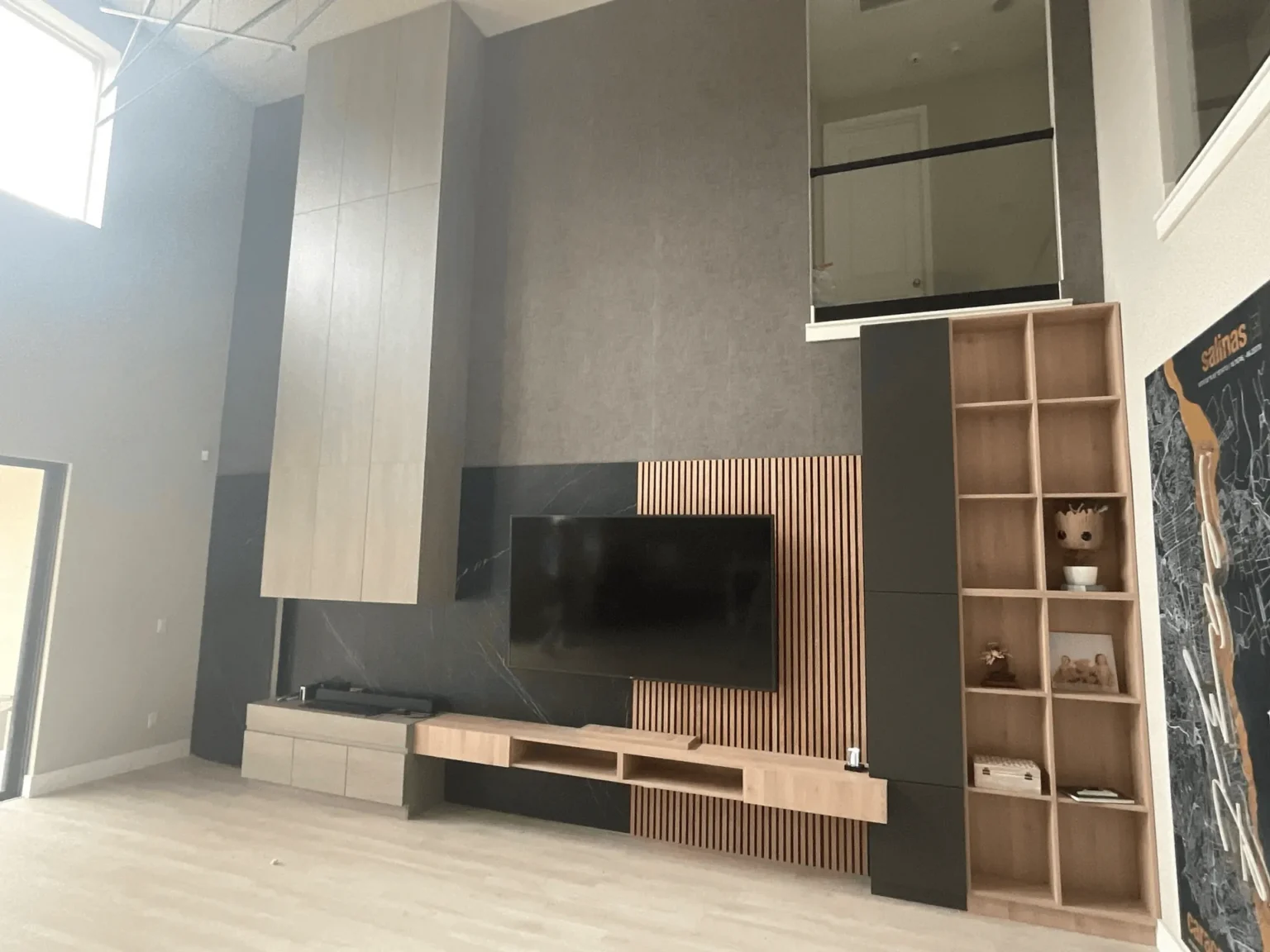 Wide view of the finished double-height living room media wall